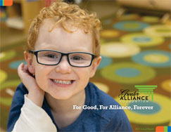 Cover of 2021 Annual Report with smiling  curly-haired child