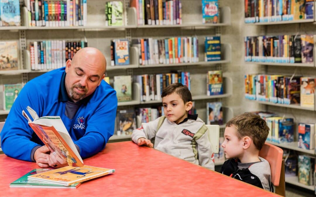 Early Childhood Education Alliance volunteer reads to kids