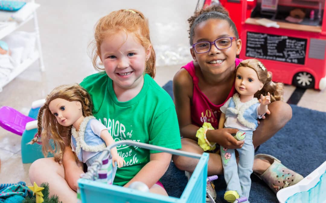 two young girls with dolls